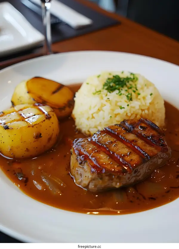 A delicious steak with rice and potatoes