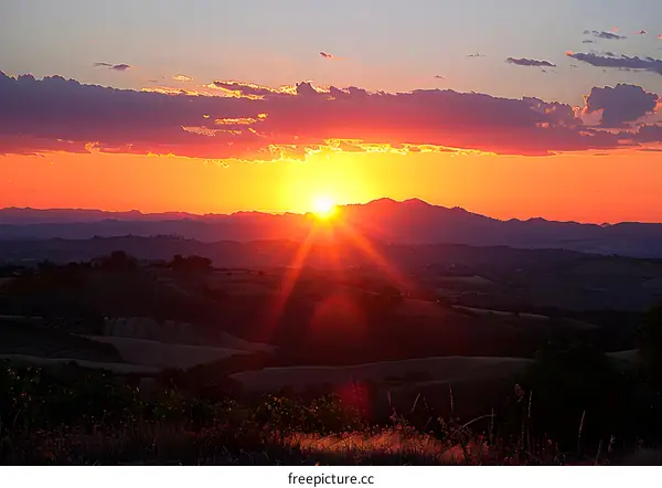 sunset over rolling hills