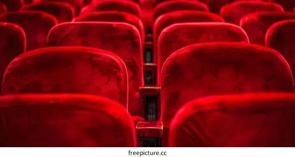 Rows of Empty Red Velvet Seats in Theater Auditorium