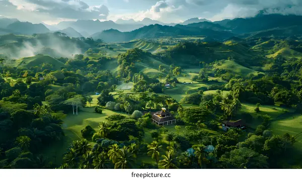 Aerial view of green hills and valley with houses