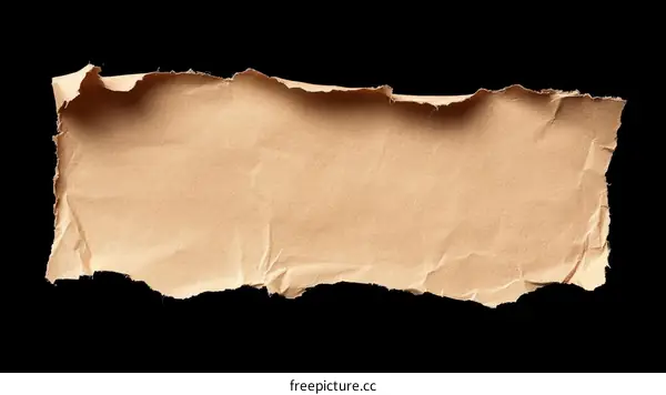 Torn Cardboard Piece Against Black Background