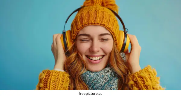 Redhead woman listening to the music with yellow headphones