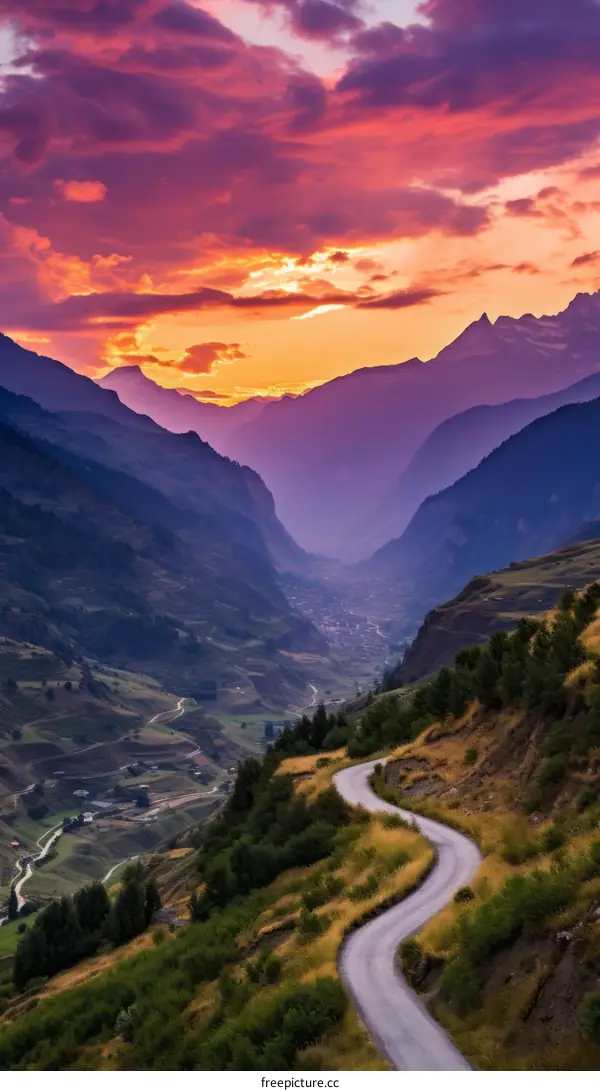Curving Road Through Mountain Valley At Sunset