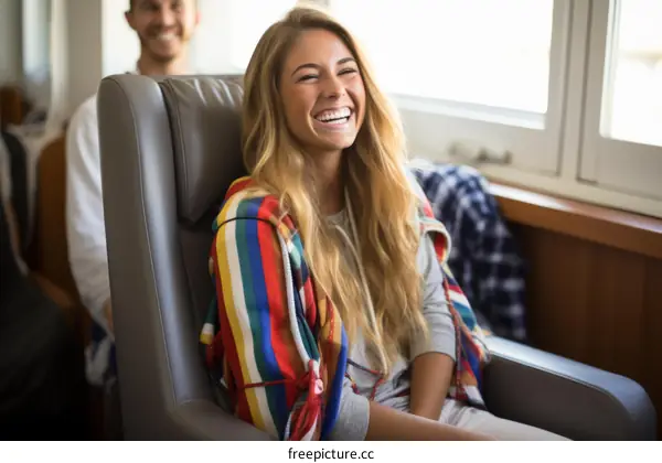 Laughing blonde woman sitting in a chair