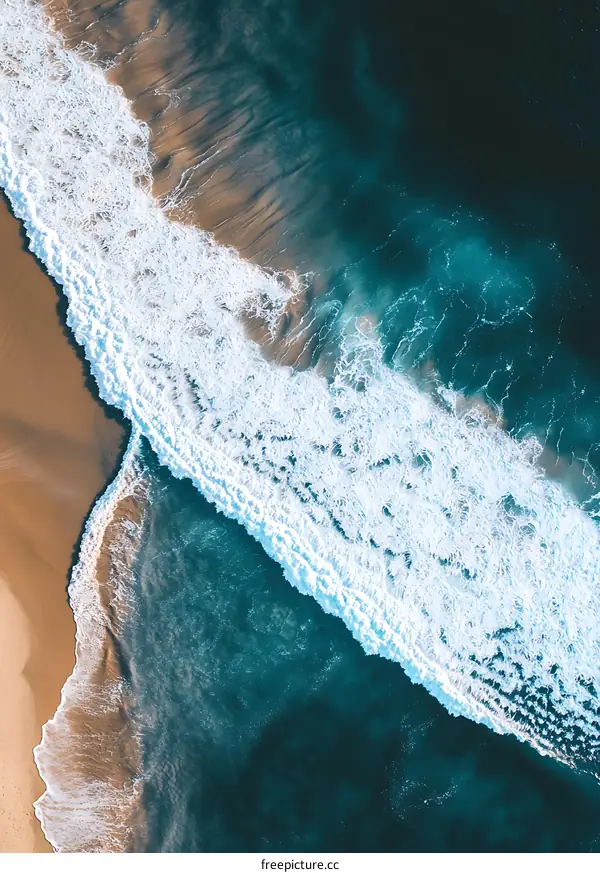Aerial View of Ocean Waves Crashing on Sandy Beach