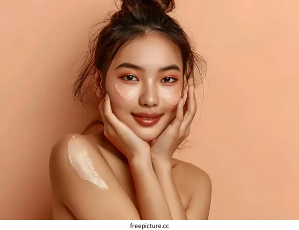 Beautiful Asian Woman with Cream on her Face and Shoulder