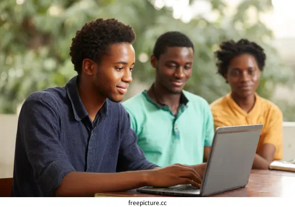 Three African Students Working Together on Laptops