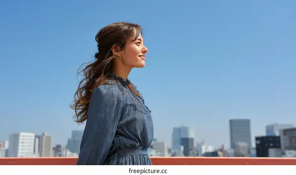Asian Woman Contemplating Cityscape