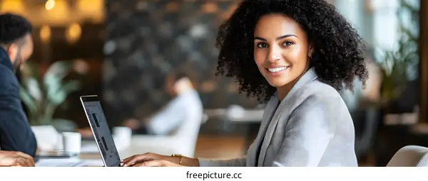 Smiling African American Businesswoman Working on Laptop