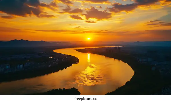 Golden Sunset Over a Winding River Cityscape