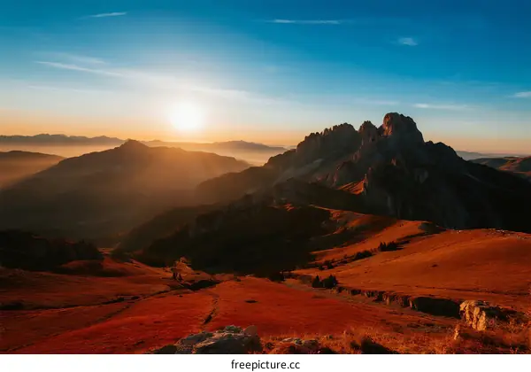 Sunrise over mountain range with golden light and clear sky
