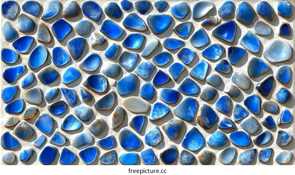 Abstract Pattern of Blue Stones on a Light Gray Wall