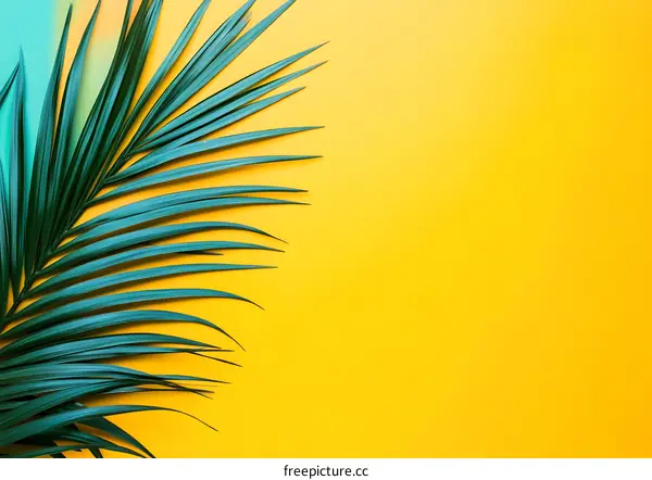 Tropical Green Palm Leaf On Yellow Background