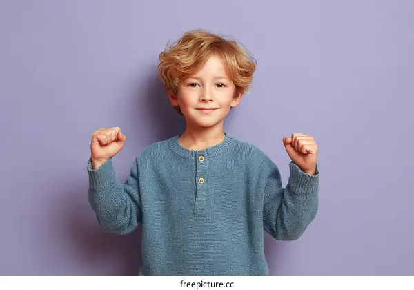 Smiling Boy in a Light Blue Sweater Against a Lavender Background