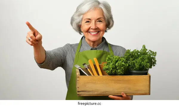 Elderly woman holding a wooden box with gardening tools and herbs