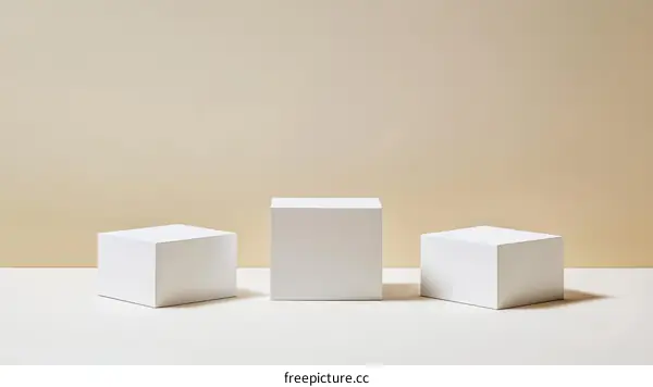 Three White Cubic Display Platforms Against a Beige Background