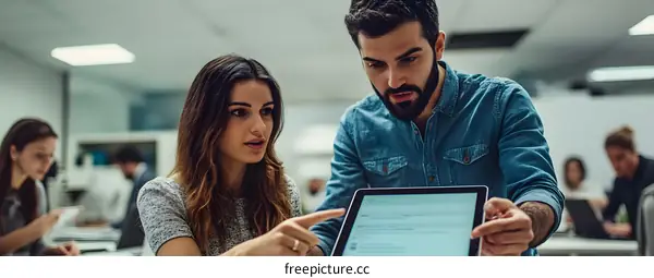 Two Colleagues Discussing Work On A Tablet
