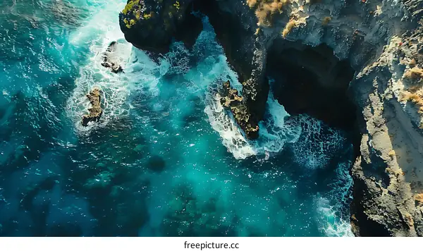 Aerial View of Ocean Waves Crashing on Rocky Coastline