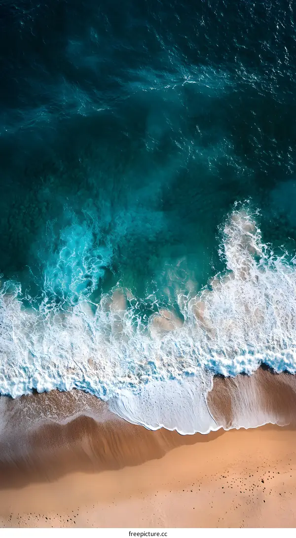 Aerial View of Ocean Waves Crashing on Sandy Beach