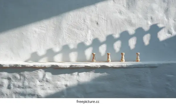 White Wall Shadows of Small Wooden Objects