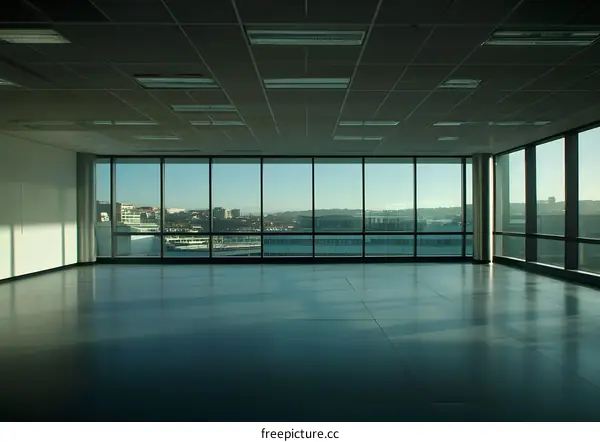 Empty Modern Office With Large Windows and City View
