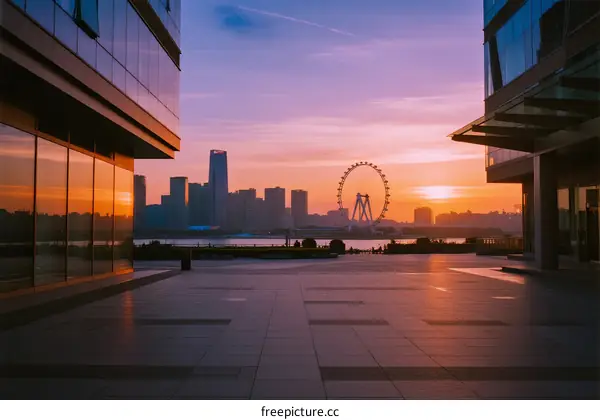 Stunning sunset view of modern cityscape with ferris wheel in the distance