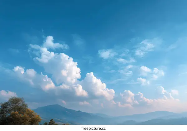 Vast Sky with Fluffy Clouds and Mountains