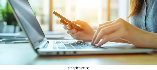 Woman Working on Laptop and Mobile Phone