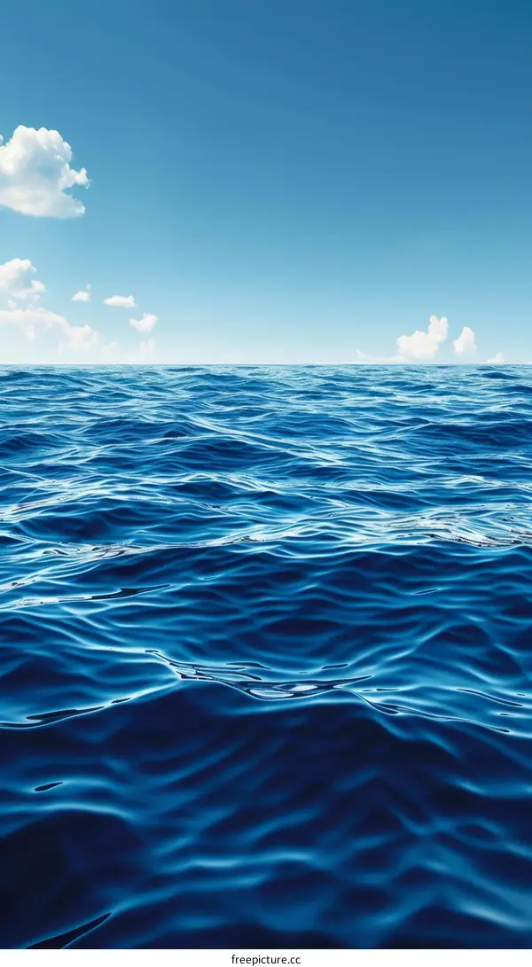 Deep blue ocean with white clouds in the sky