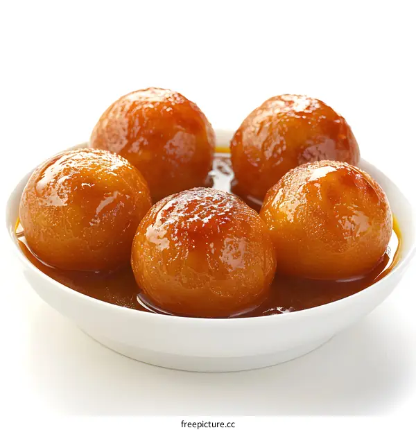 Four gulab jamun in white bowl