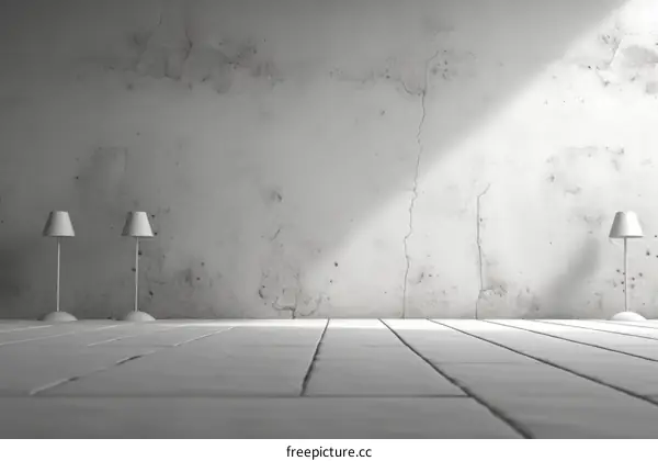 Two white lamps in front of a white concrete wall with cracks