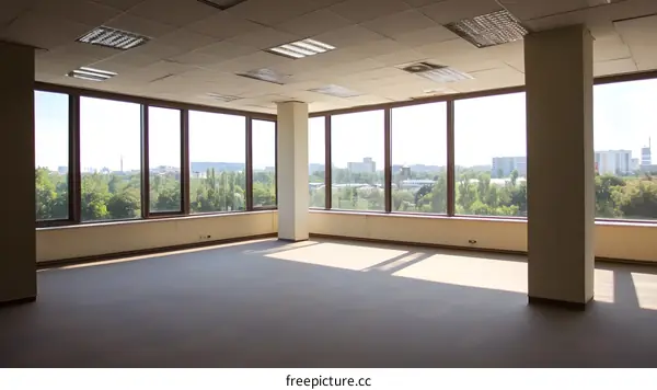 Empty Office Room with Large Windows and City View