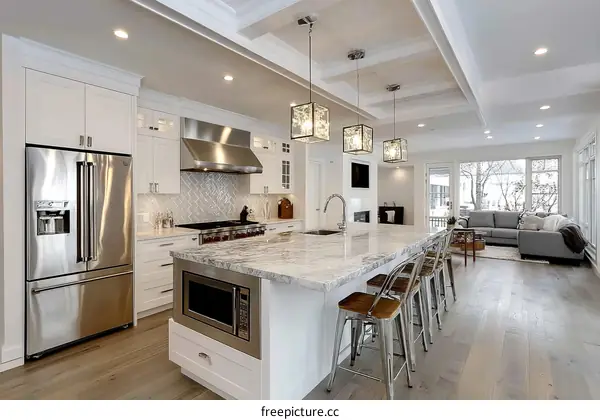 Modern White Kitchen with Granite Island and Open-Concept Living