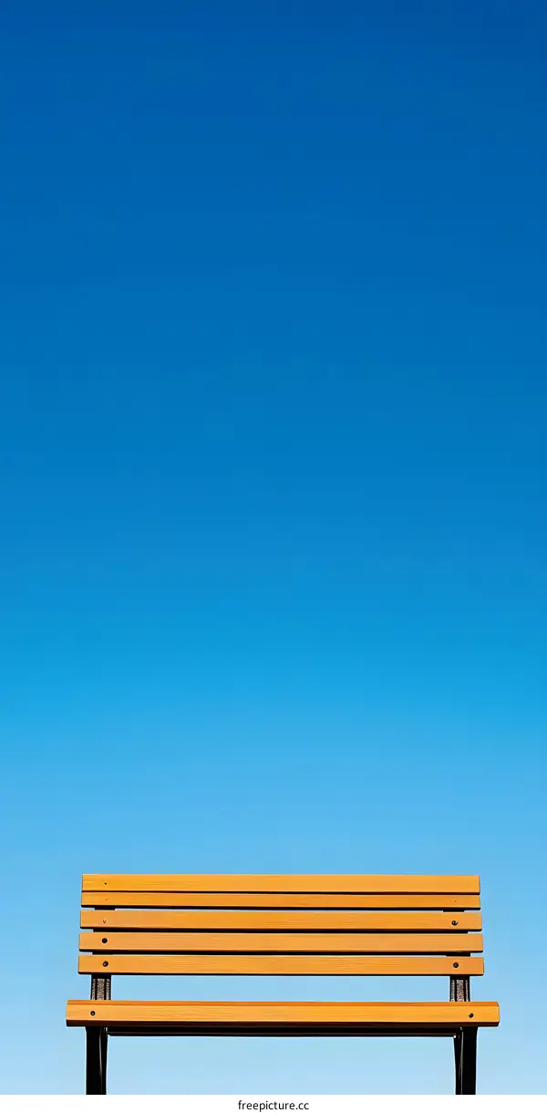 Wooden Bench Against Blue Sky