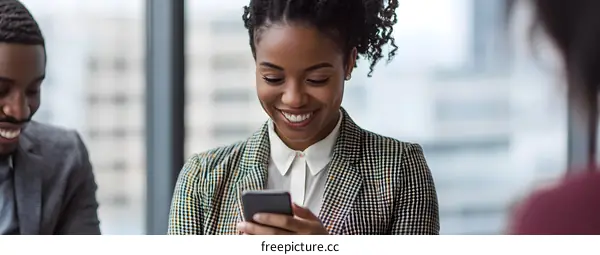 Smiling Businesswoman Using Phone in Office