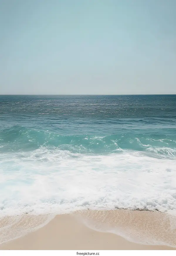 Blue Ocean Waves Crashing on Sandy Beach Shore