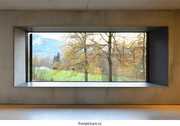 Modern Concrete Wall with Large Window View of Autumn Landscape