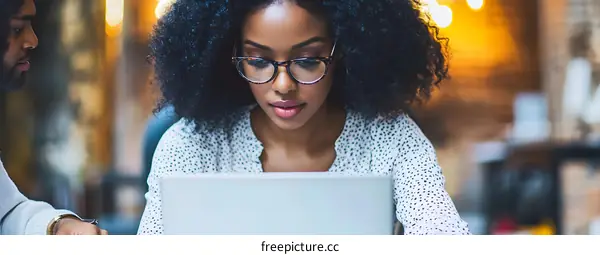 African American Woman Working On Laptop In Office