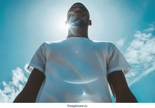 Man Standing With Sun Glowing Behind Him