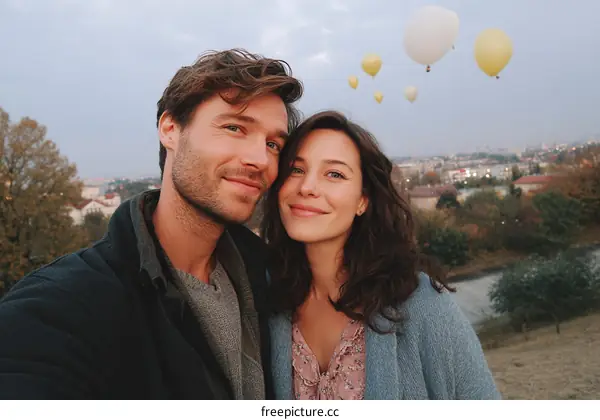 Couple Posing with Hot Air Balloons Over City