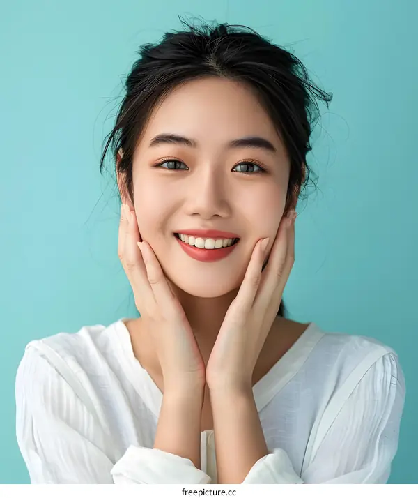 Happy Asian Woman with Beautiful Skin Touching her Face