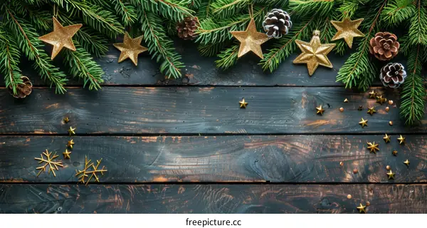 Christmas Background with Golden Decorations and Fir Tree Branches on Dark Wooden Table
