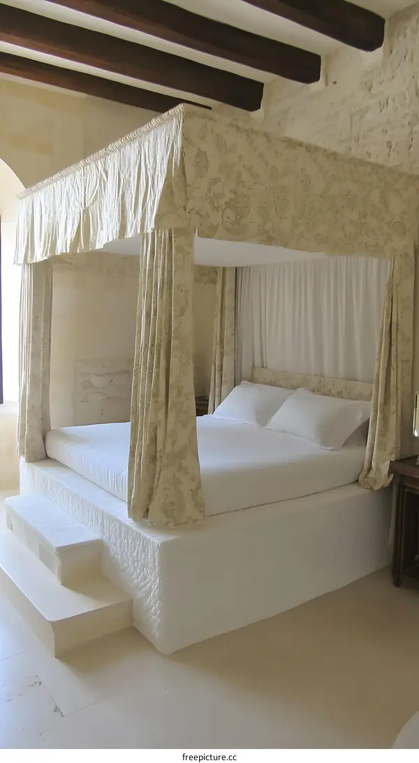 Four Poster Bed in a Luxurious Bedroom with White Walls and Wooden Beams