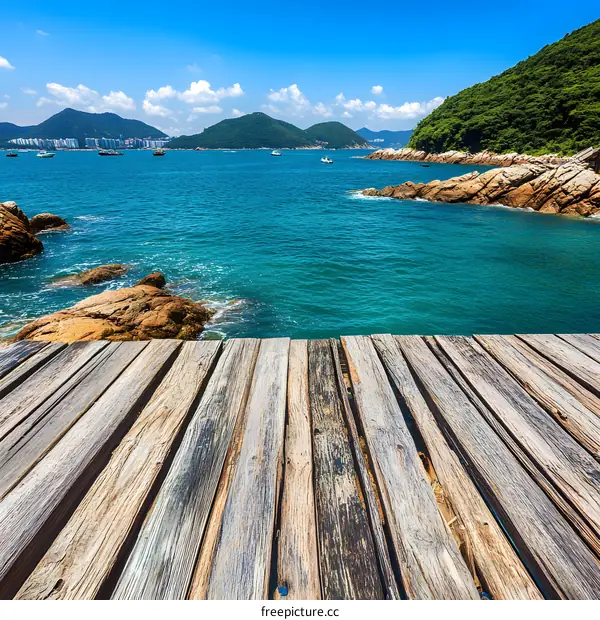 Wooden Deck Overlooking Blue Ocean Water And Green Mountains