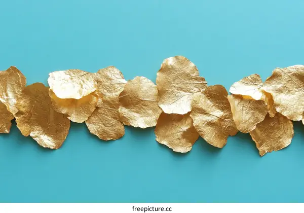Golden Leaf Petals on Teal Background