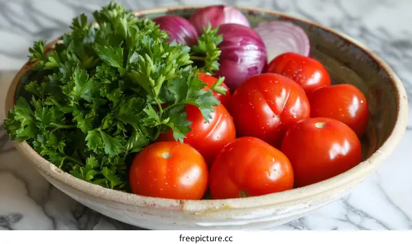 A bowl of tomatoes, onions, and parsley