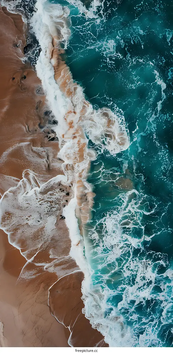 Aerial View of Ocean Waves Crashing on Sandy Beach