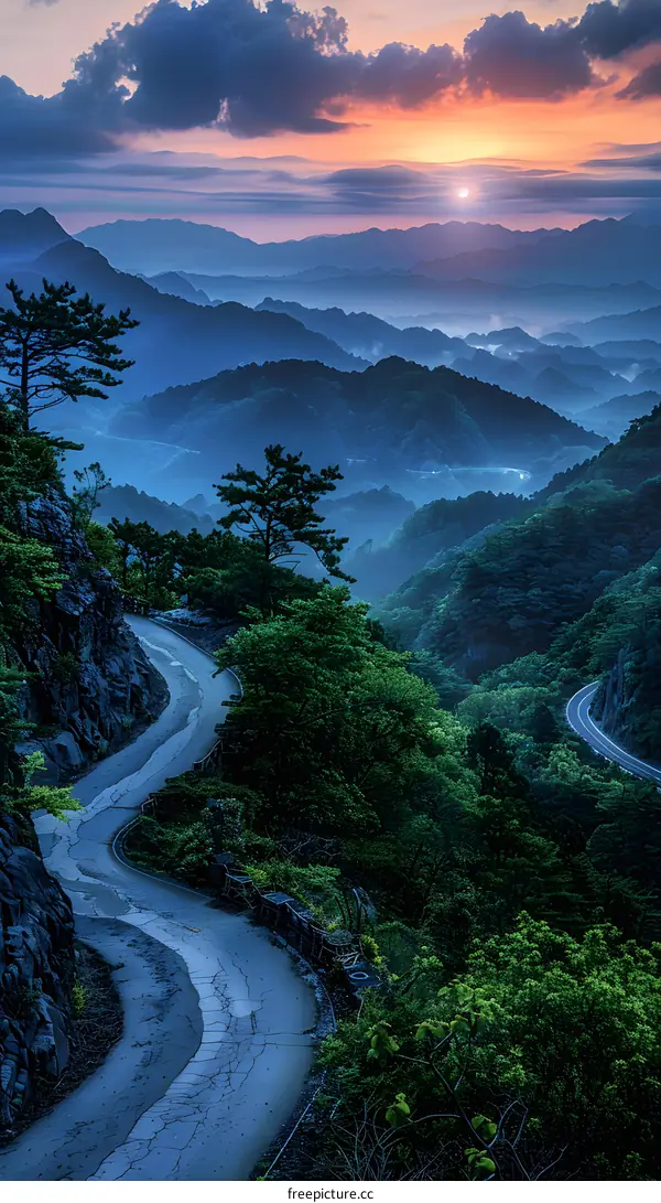Winding Road Through Lush Green Mountains at Sunrise