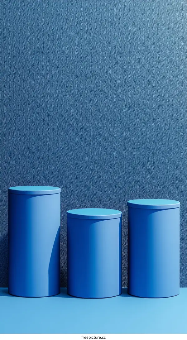 Three Blue Cylindrical Podiums Against a Dark Blue Background