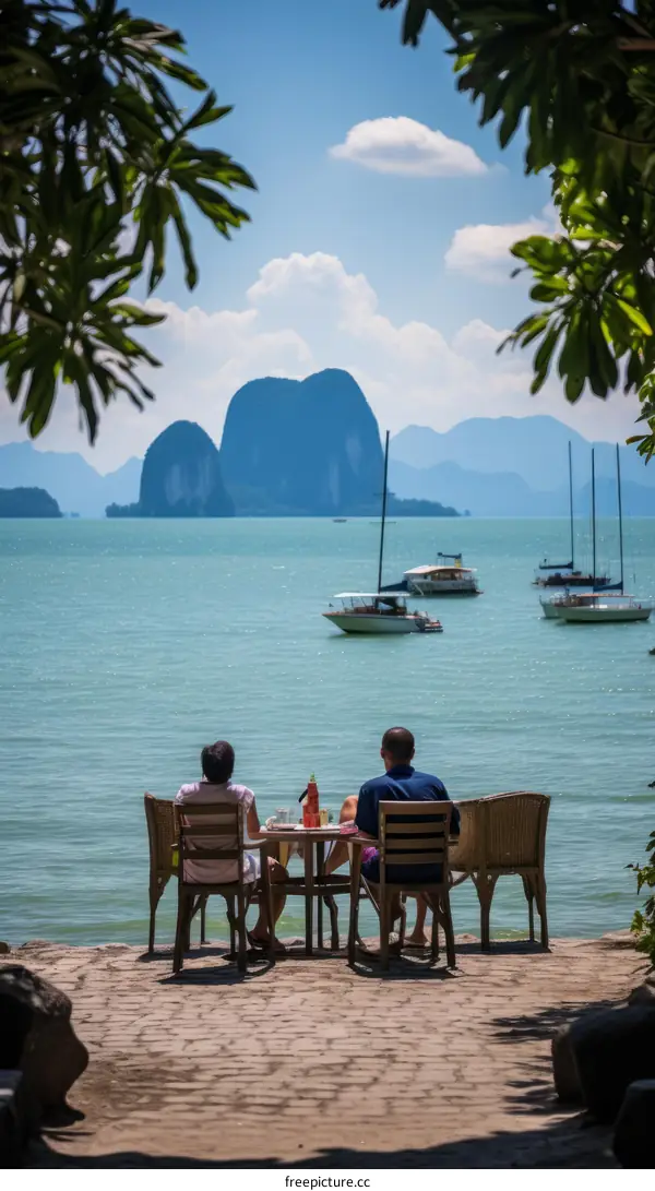 A couple is sitting on the terrace of a house enjoying the view of the sea